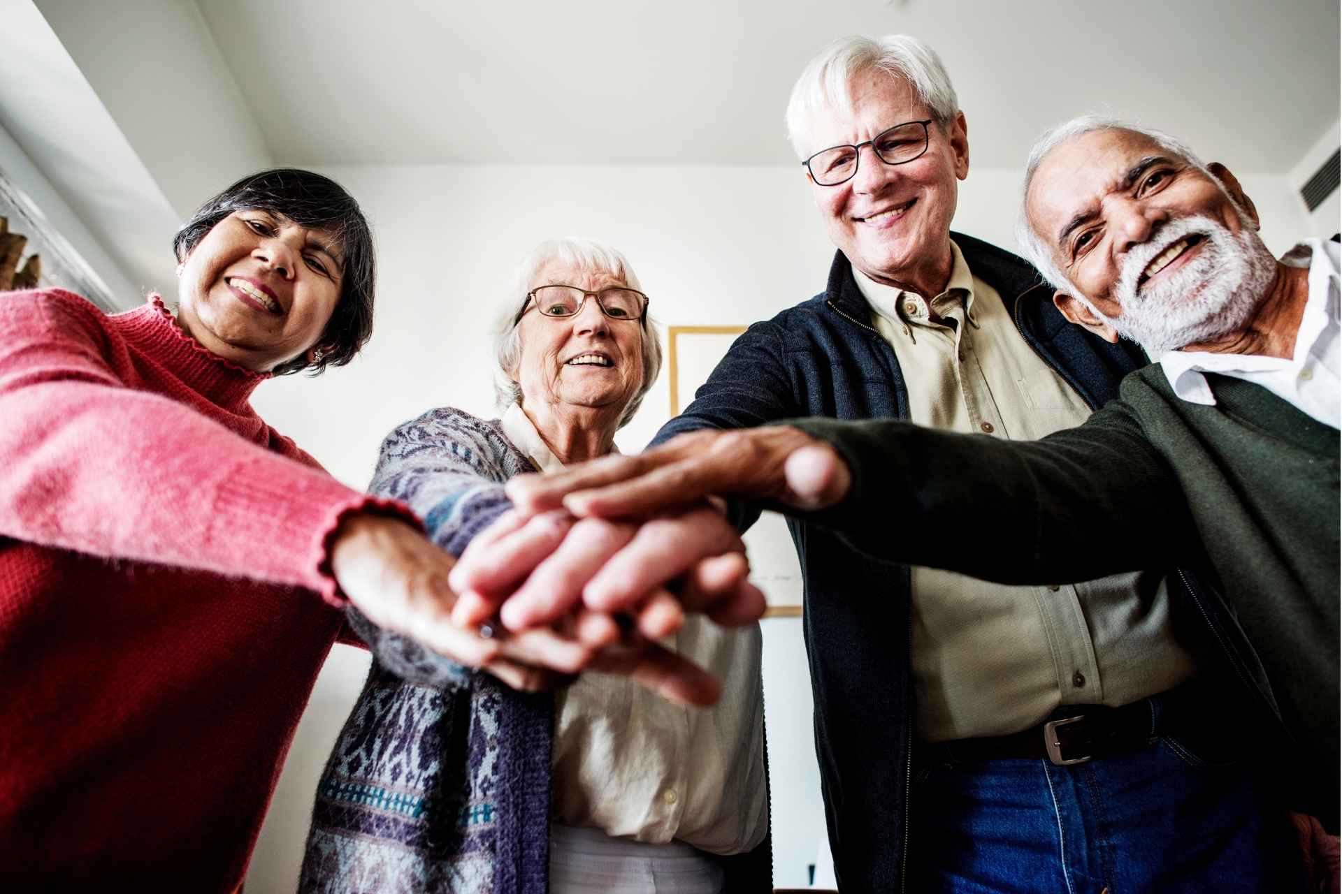 seniors standing in a circle with their hands in the center